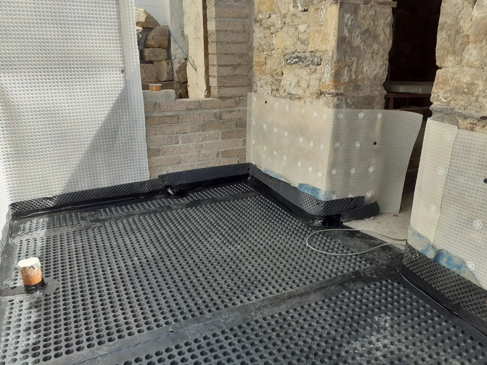 Cavity drain waterproofing membrane installed in a commercial basement