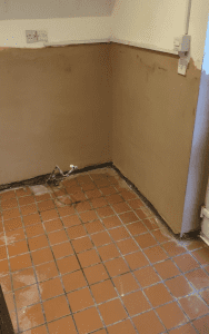 Screenshot 2026 03 10 at 12.35.30 Damp staining and deteriorating plaster on a ground-floor wall before treatment