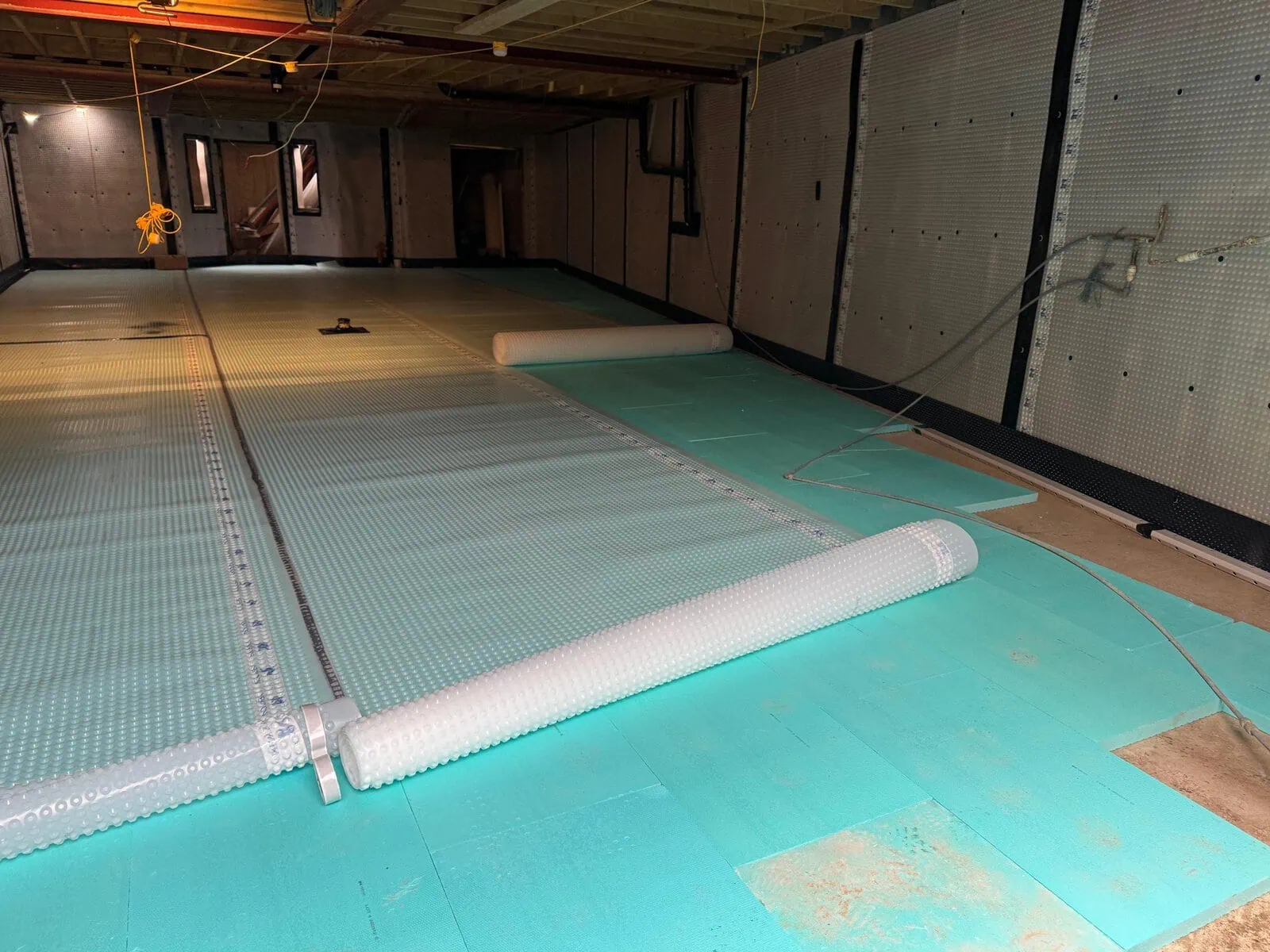 newton basement waterproofing system scaled Newton basement waterproofing floor membrane being installed over insulation board