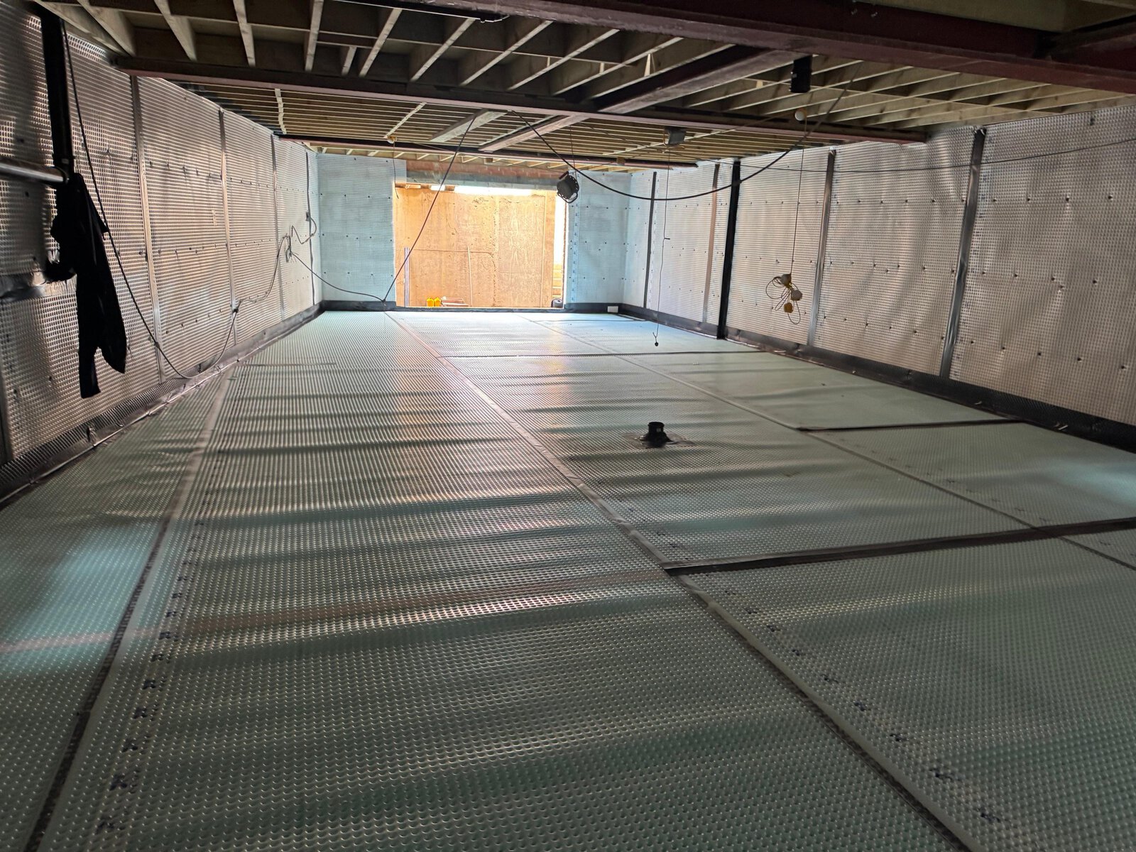 structural basement waterproofing scaled Newton floor membrane laid over XPS insulation across the basement slab
