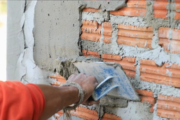 spreading plaster onto brickwork